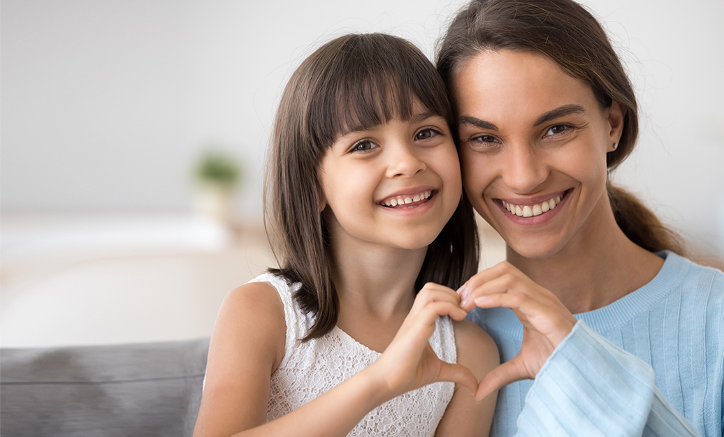 mother and daughter smiling at camera