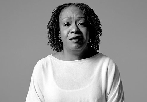 black and white photo of woman looking into camera with a somber expression