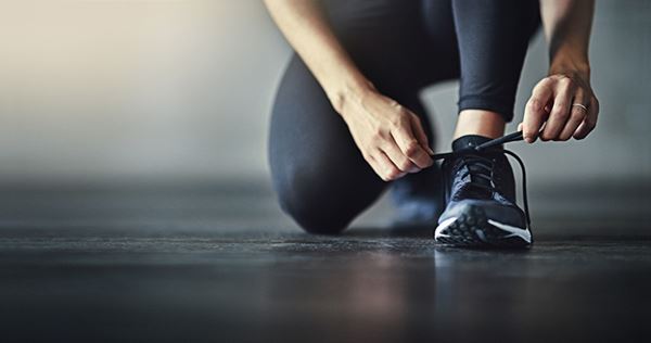 runner tying shoe GettyImages-618982838 young woman sitting at laptop