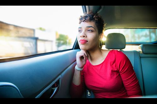 peaceful woman looks out car window man and woman hugging