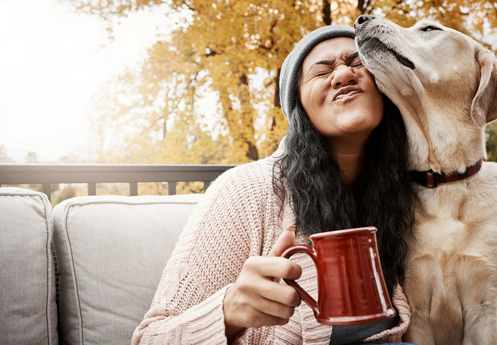 woman snuggles dog
