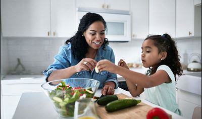 Mom and daughter make salad in kitchen Mom and daughter make salad in kitchen