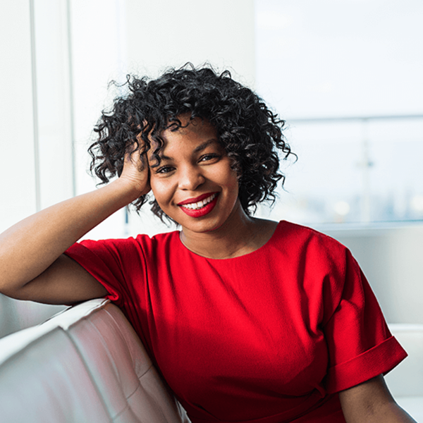 Woman sitting on couch and smiling