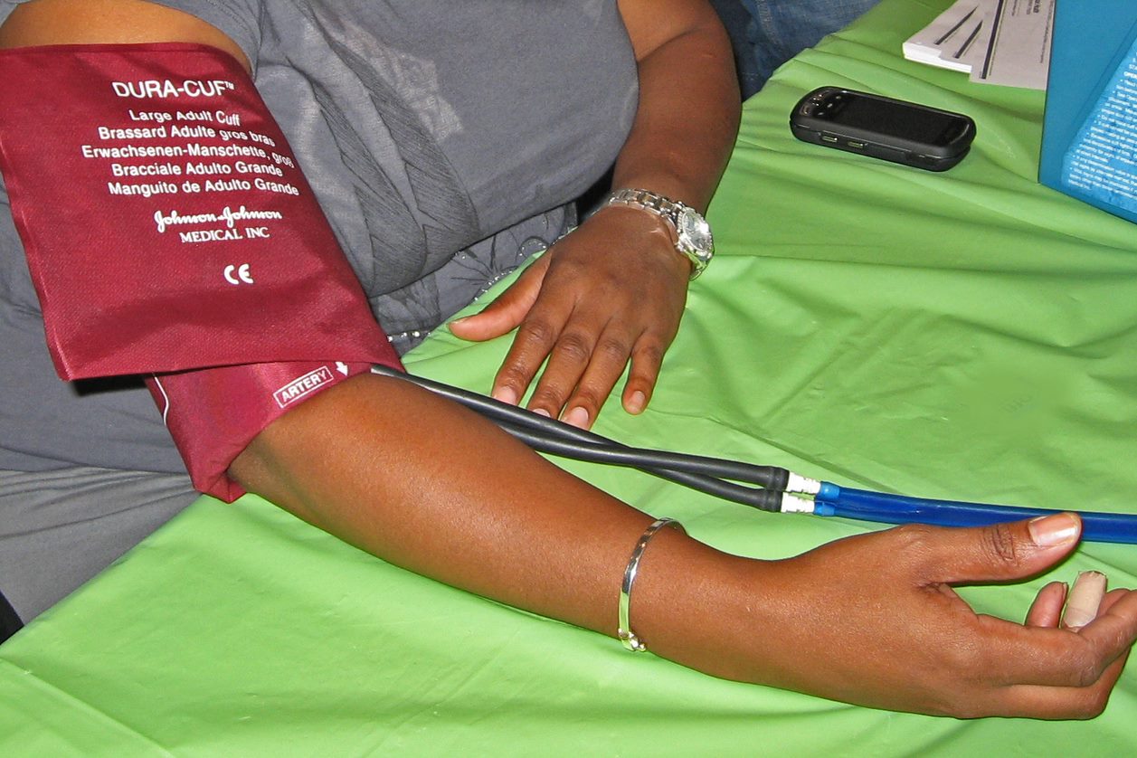 Arm with blood pressure cuff around it