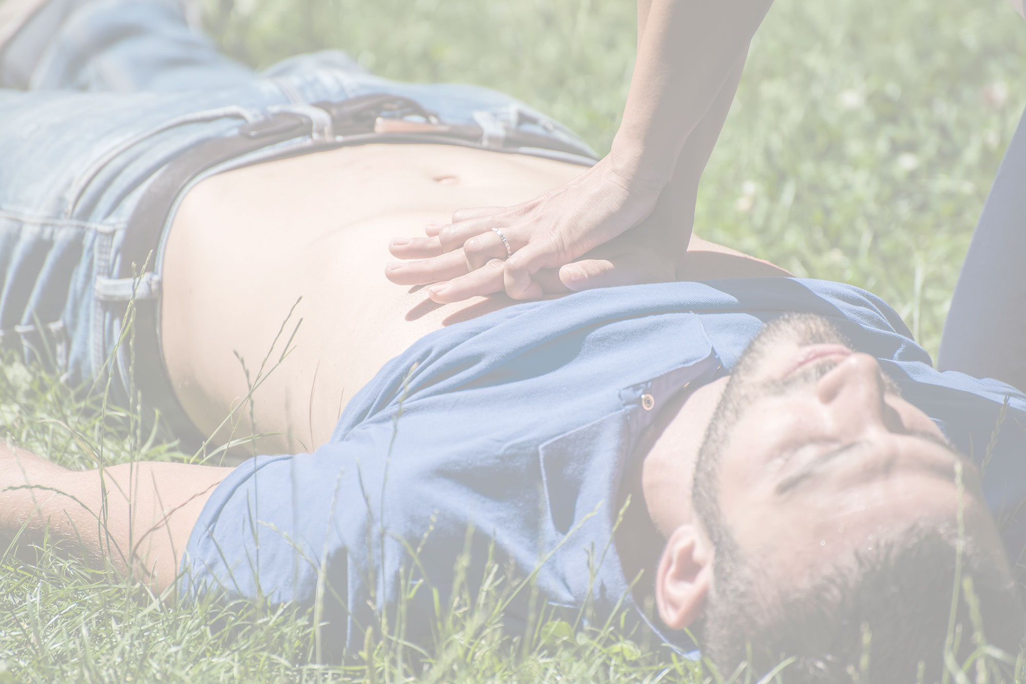 CPR performed on a male collapsed in the grass