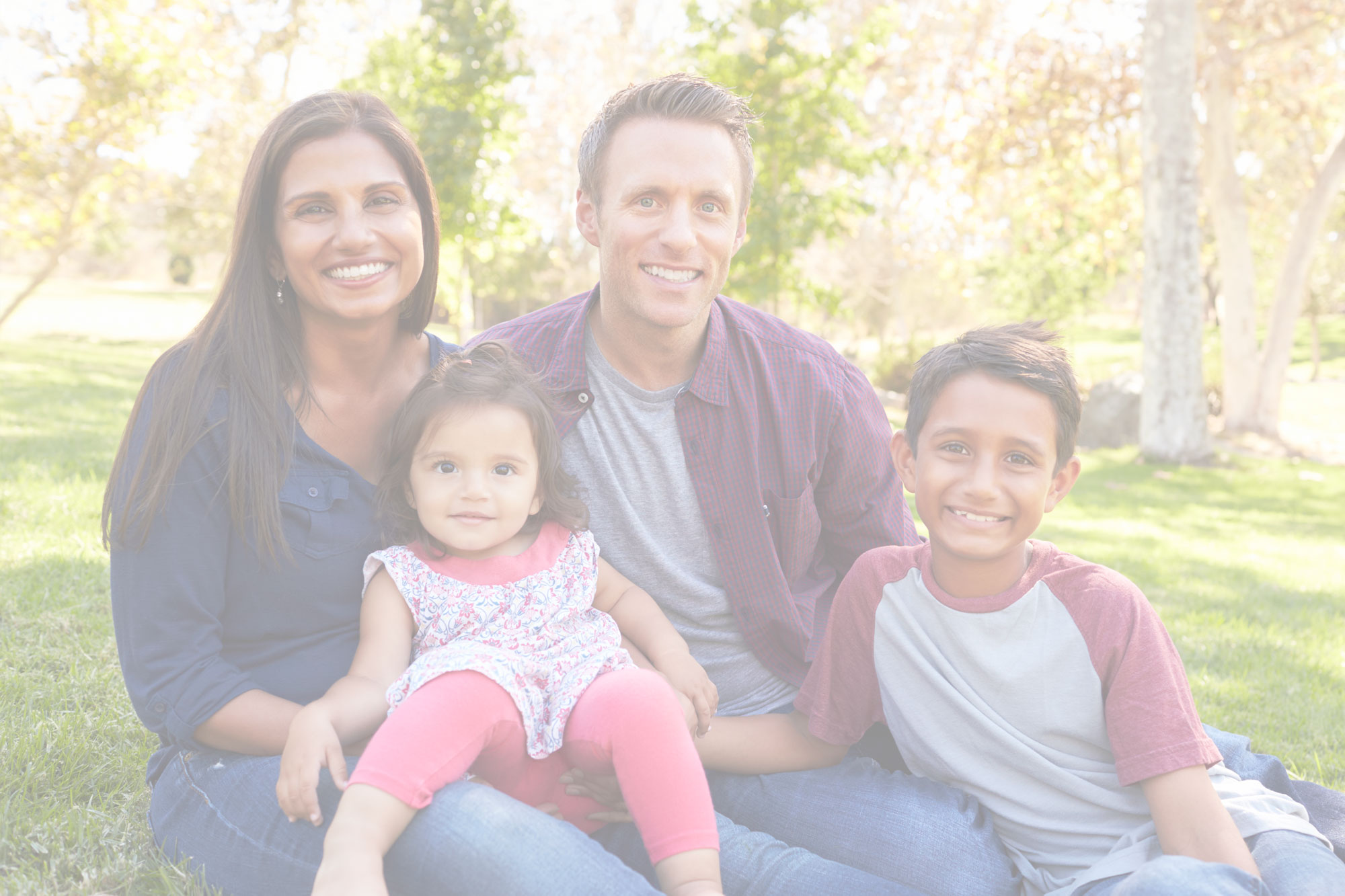 Family of four sitting at the park