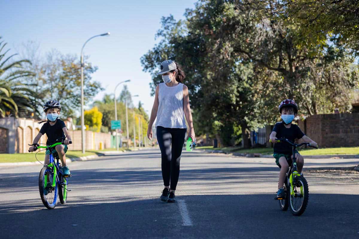 mom with kids biking