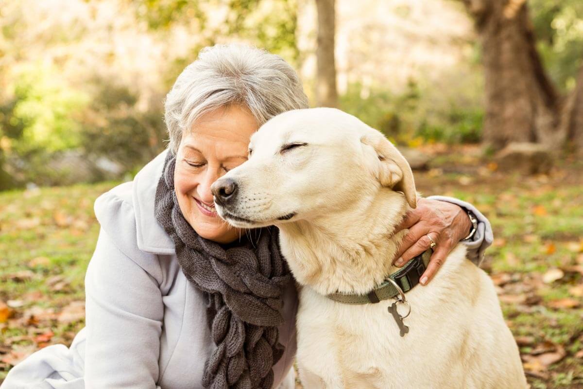 senior woman hugging her dog