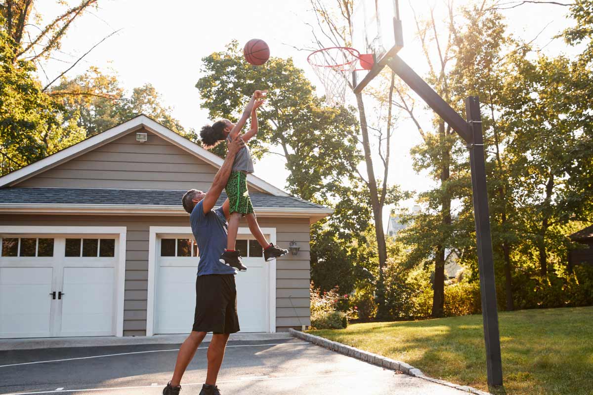 dad and daughter playing basketball