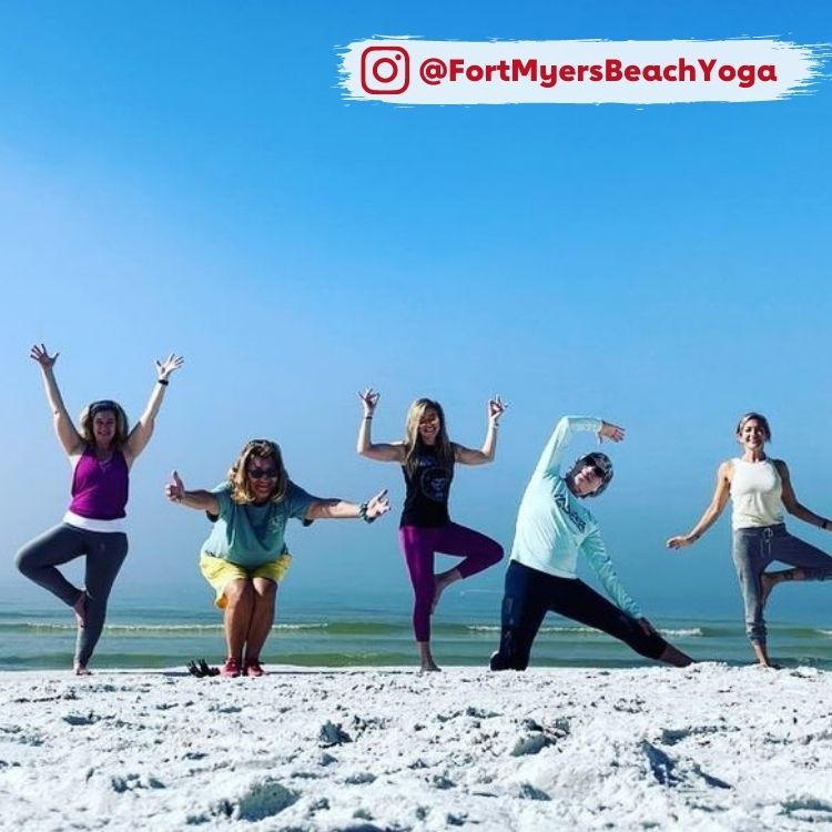 people doing yoga on the beach