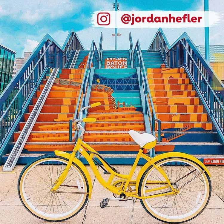 yellow bike parked in front of staircase