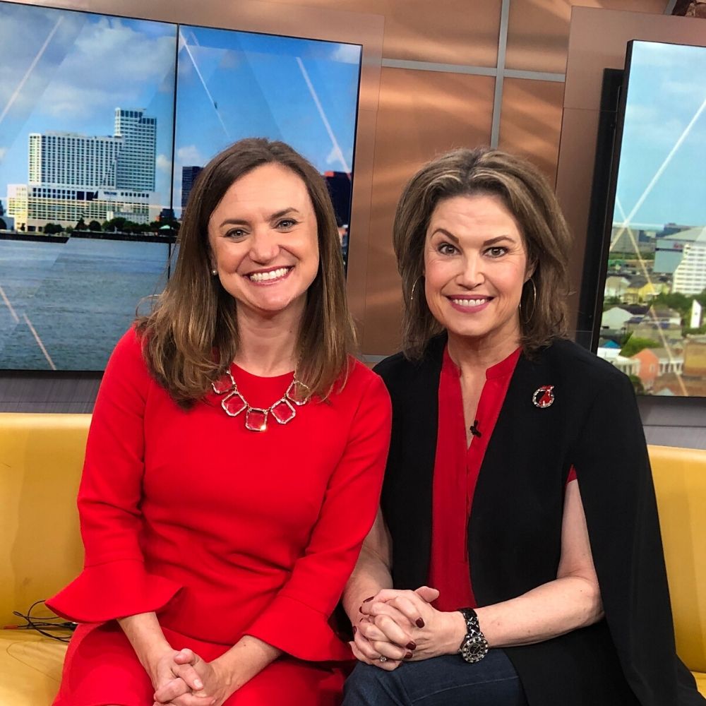 Brittany Gay seated with woman in red