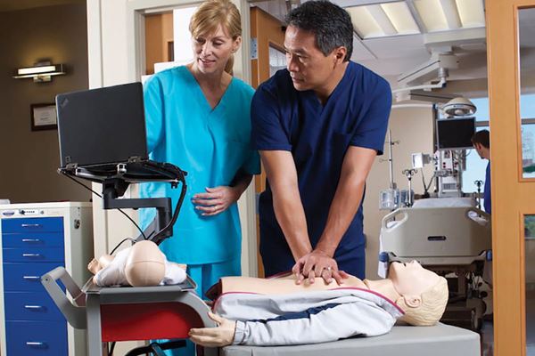 Medical professionals practicing Hands Free CPR with a dummy