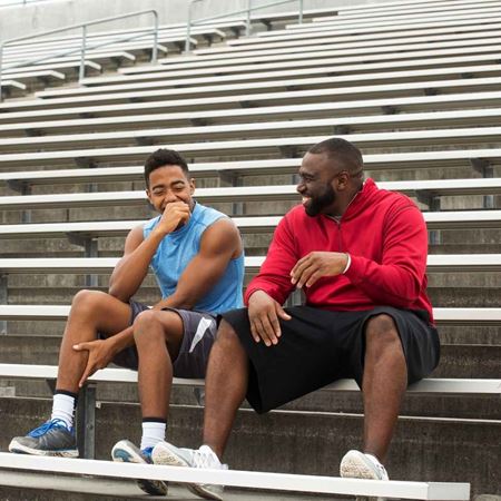 men sitting on bleachers