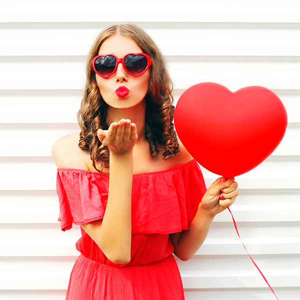 Woman Holding Red Heart Balloon