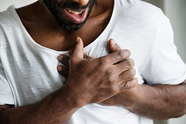 man holding his hands to his heart