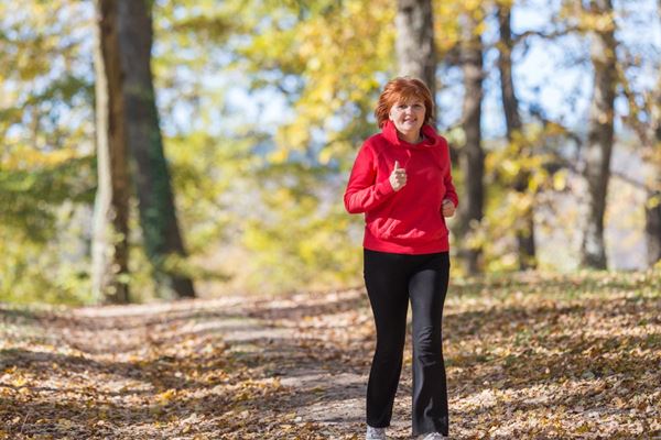 woman in red hiking in woods