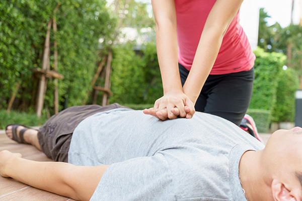 Woman giving man CPR