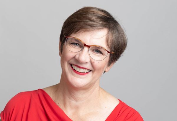 A smiling women in a red dress