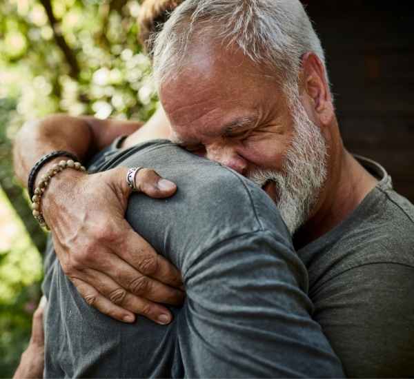 A man hugging his son