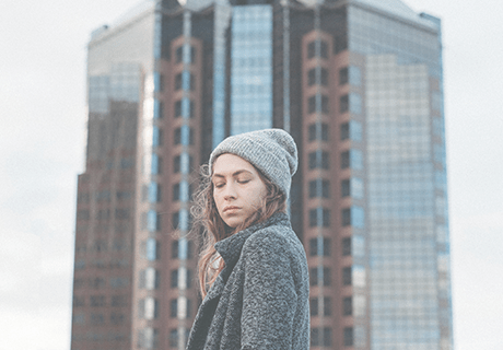Sacramento woman standing in front of glass skyscrapper