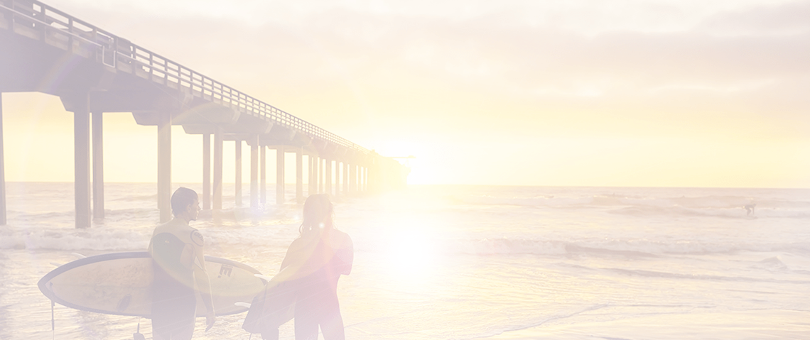 San Diego header image surfers at sunset on the beach in San Diego