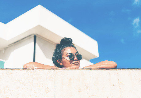 woman peering over wall in Hawaii