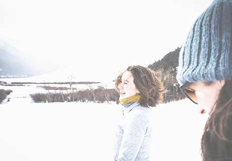 two women laughing in the snow