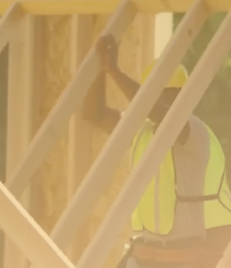 construction worker lifting a frame