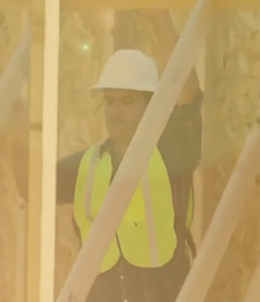 construction worker lifting a frame
