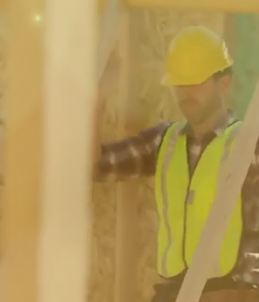 construction worker lifting a frame