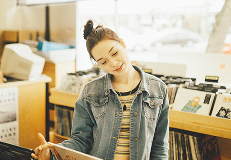 Puget Sound contact 2 girl looking through records in Seattle store