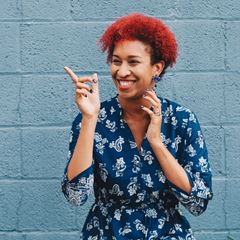 women with red curly hair laughing