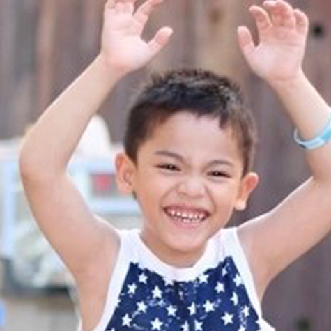 Meet WSA Kids With Heart - Elijah Elijah - young boy raising arms in excitment