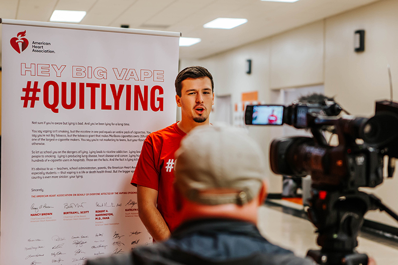 Students holding signs to support Quit Lying campaign