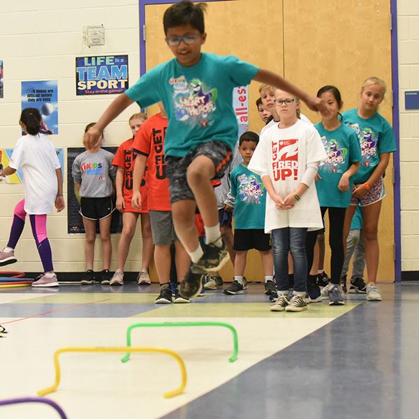 boy jumping in gymnasium boy jumping in gymnasium