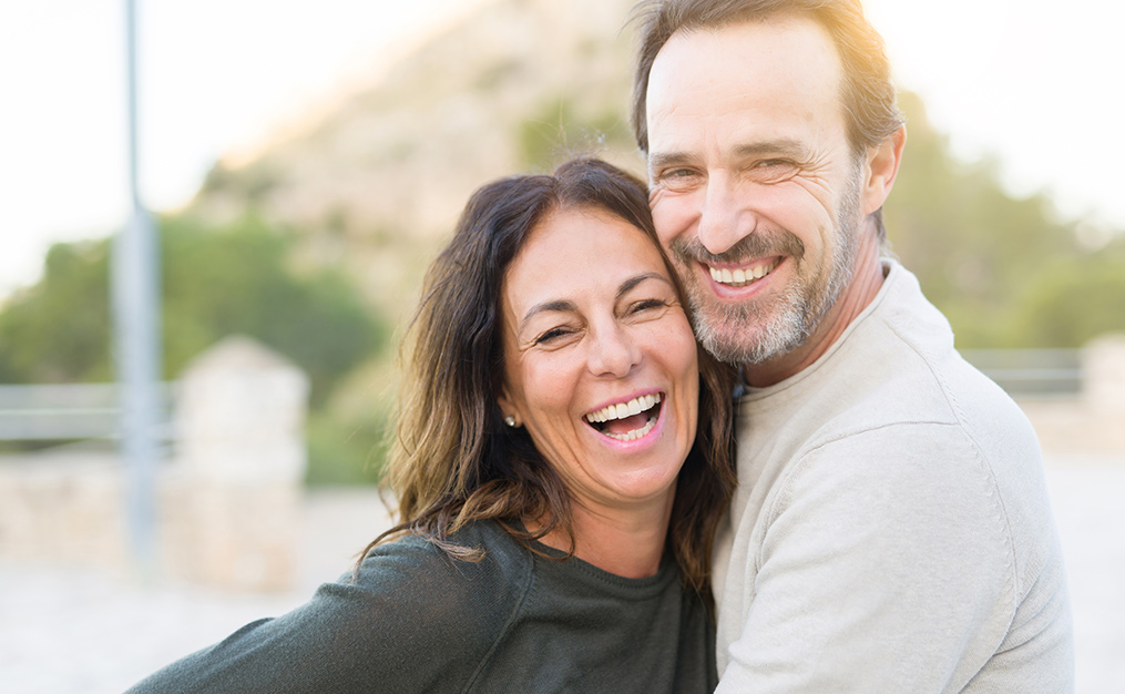 man and woman couple smiling at camera