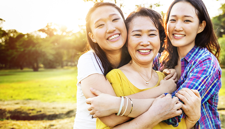 Ways to Give page header image two daughters smiling and hugging happy mother
