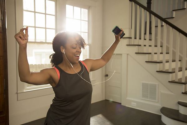 Woman exercising while listening to music Woman exercising while listening to music