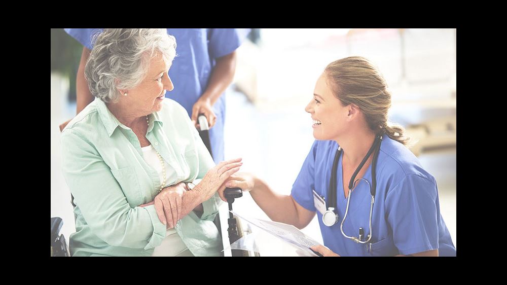 surgeon or doctor smiling at senior woman surgeon or doctor smiling at senior woman