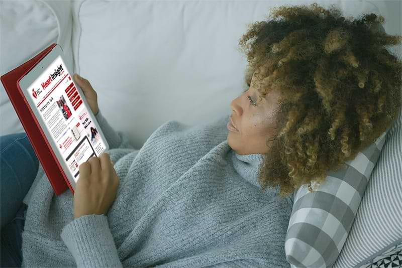 Woman reading Heart Insight on her tablet