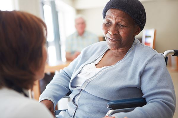 elderly patient in wheelchair speaks to doctor elderly patient in wheelchair speaks to doctor