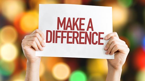 Hands holding up a sign that says Make A Difference