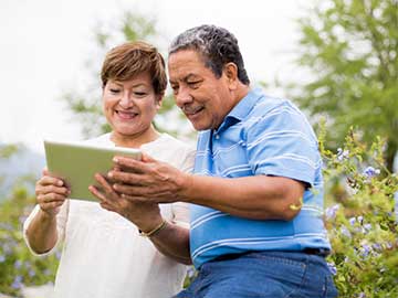 man and woman couple looking at tablet device - aldomurillo/E+, Getty Images