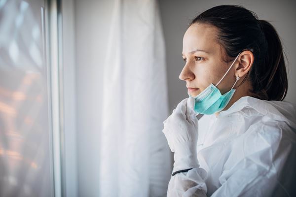 COVID Doctor looking out window