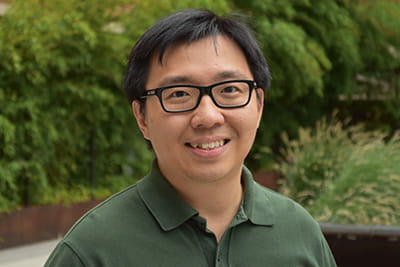 A casual headshot of Gary Chan, PhD in an outdoor setting