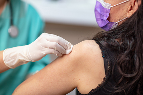 Woman receiving COVID vaccination
