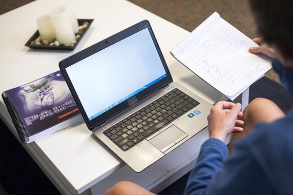 man at laptop with PALS guide man at laptop with PALS guide
