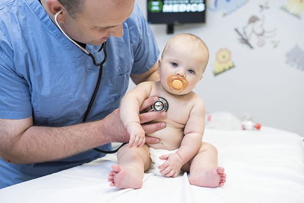 Doctor with stethoscope on infants chest doctor with stethoscope on infants chest