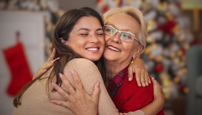 Two women hugging in the living room